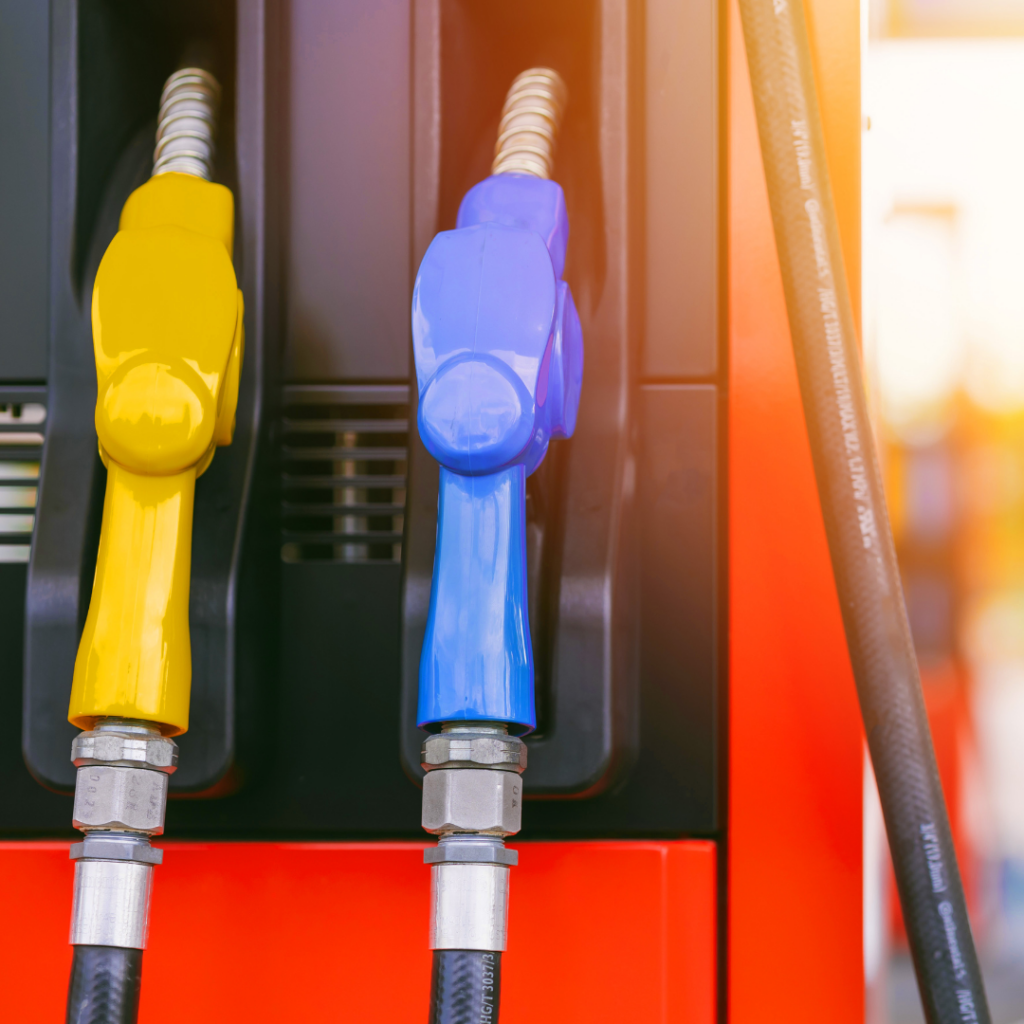 Yellow gas pump next to blue gas pump in red docking station